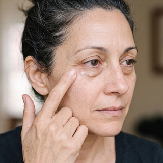 Ring finger patting cream under the eye